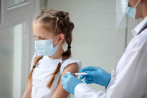 Doctor vaccinating child
