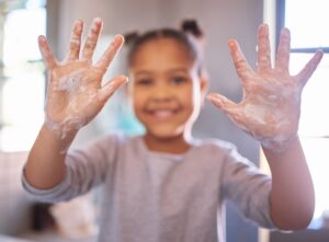 child washing their hands.